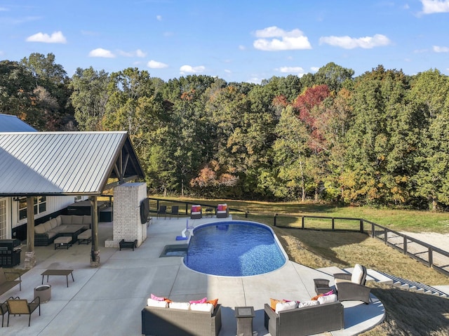 view of pool featuring a patio, outdoor lounge area, grilling area, and a lawn