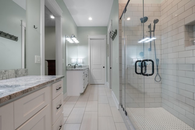 bathroom featuring vanity, an enclosed shower, and tile patterned floors