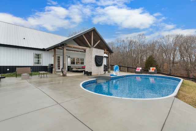 view of swimming pool with an outdoor living space and a patio area