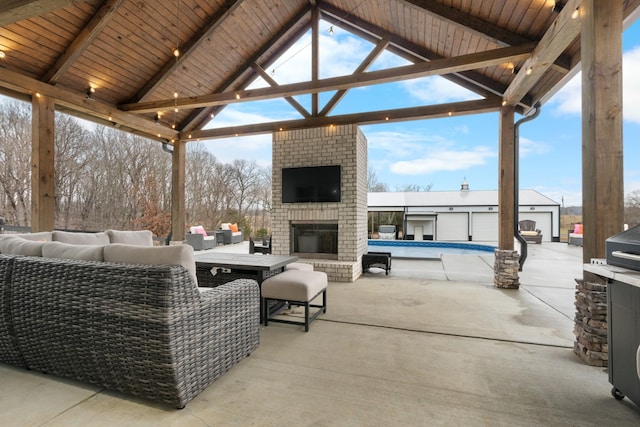 view of patio / terrace featuring a gazebo, an empty pool, and an outdoor living space with a fireplace