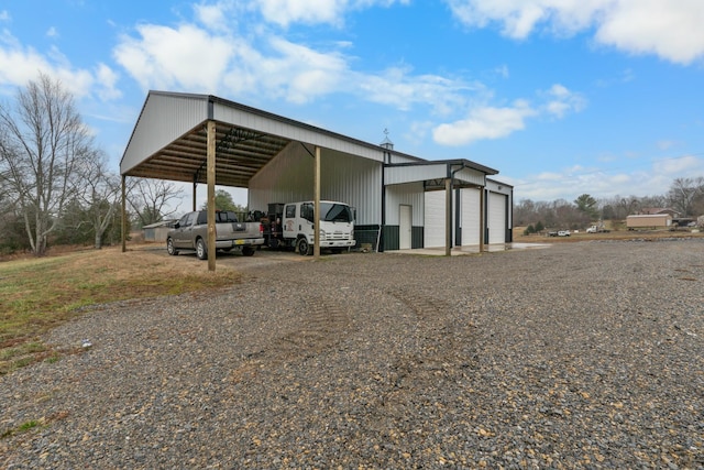 view of outbuilding with a carport and a garage