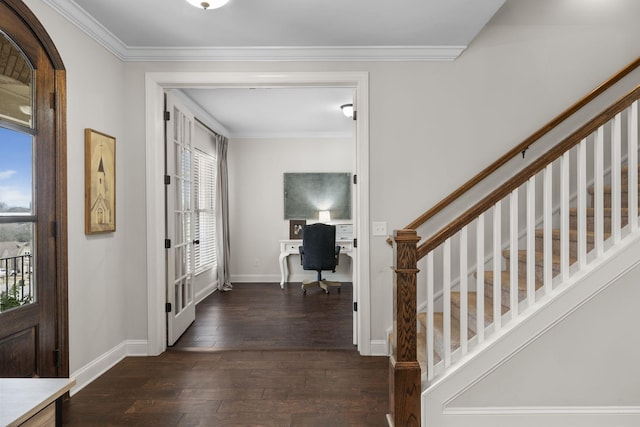 foyer entrance with ornamental molding and dark hardwood / wood-style flooring