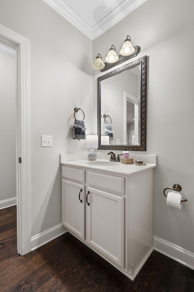 bathroom with ornamental molding, hardwood / wood-style floors, and vanity