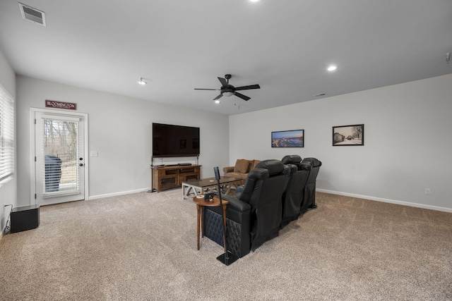 carpeted living room with ceiling fan