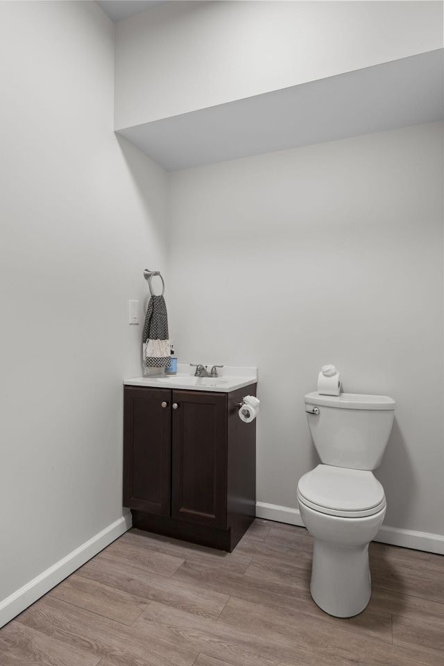 bathroom featuring hardwood / wood-style flooring, vanity, and toilet