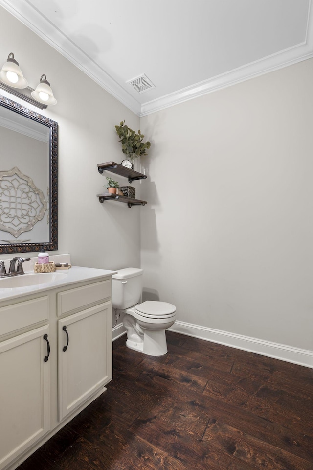 bathroom featuring crown molding, vanity, toilet, and hardwood / wood-style floors