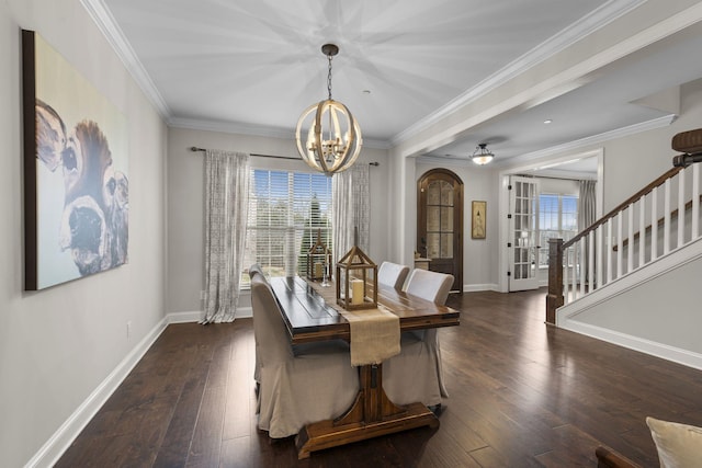 dining room featuring an inviting chandelier, ornamental molding, and dark hardwood / wood-style floors