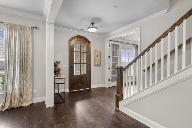 foyer entrance with crown molding and dark hardwood / wood-style flooring