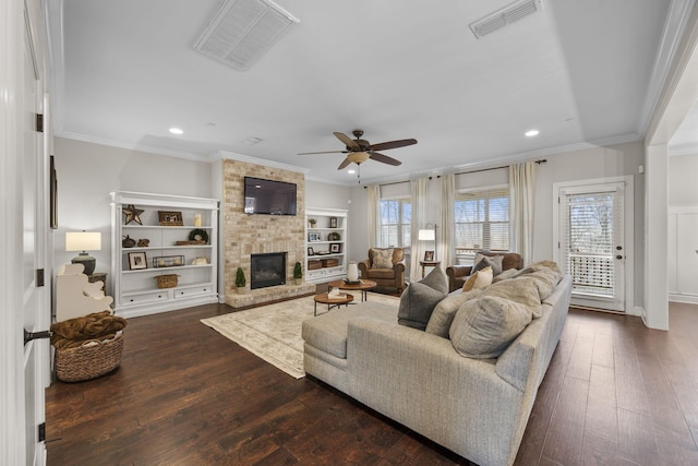 living room with crown molding, dark hardwood / wood-style floors, and a fireplace