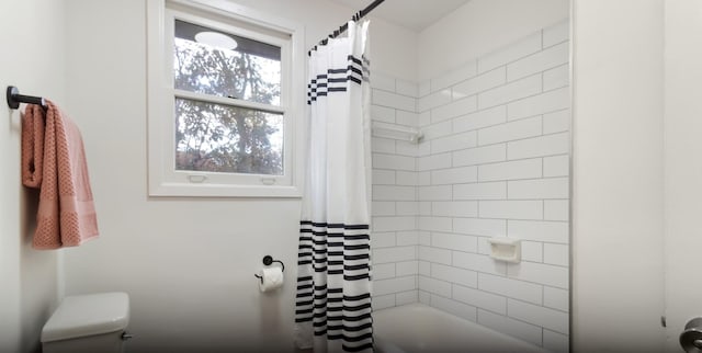 bathroom with toilet and shower / bath combo with shower curtain