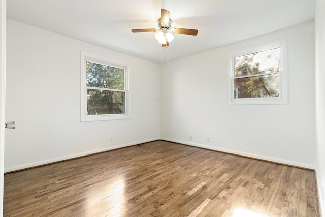 unfurnished room with hardwood / wood-style flooring and ceiling fan