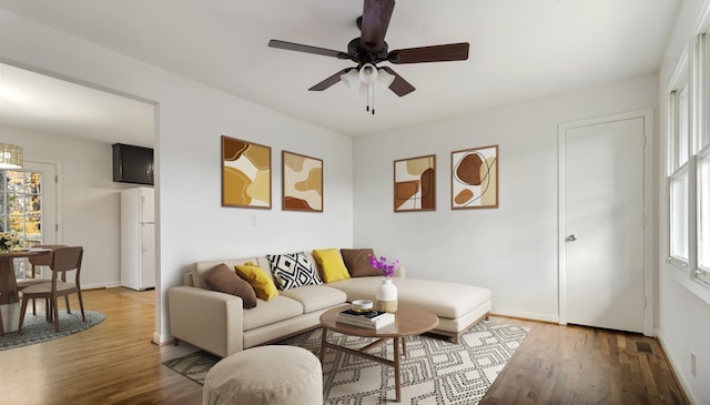 living room featuring wood-type flooring, a wealth of natural light, and ceiling fan