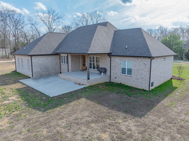 rear view of property featuring a yard and a patio area