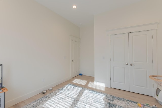 bedroom featuring light hardwood / wood-style flooring and a closet