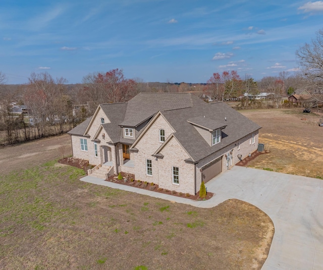 view of front of home with a garage and a front lawn