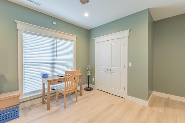 home office with light hardwood / wood-style flooring