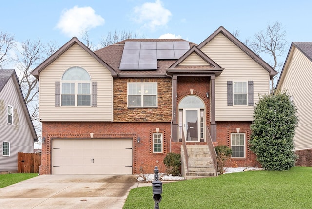 split foyer home with a garage, a front lawn, and solar panels