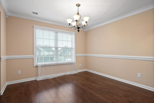 empty room featuring an inviting chandelier, ornamental molding, and hardwood / wood-style floors