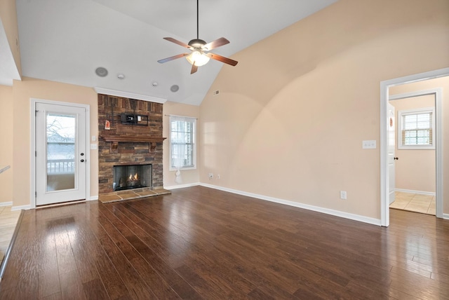 unfurnished living room with hardwood / wood-style flooring, a healthy amount of sunlight, and a fireplace