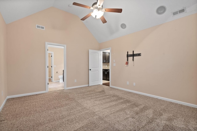 unfurnished bedroom with light carpet, high vaulted ceiling, ceiling fan, and ensuite bathroom