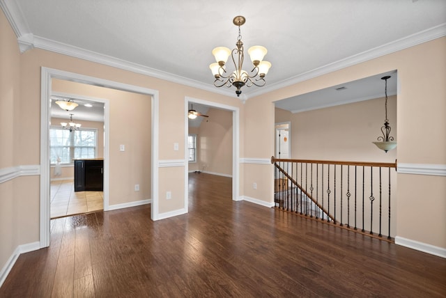 unfurnished room with crown molding, dark wood-type flooring, and ceiling fan with notable chandelier