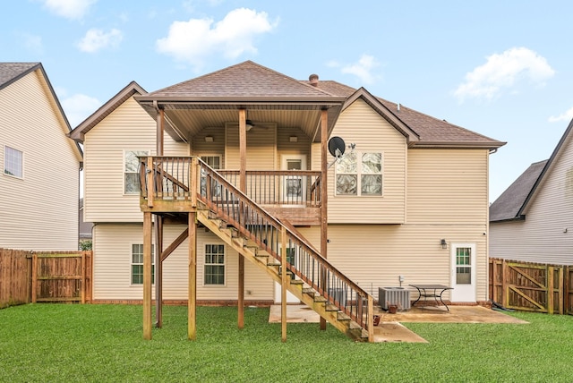 rear view of property with a patio, central AC, ceiling fan, and a lawn