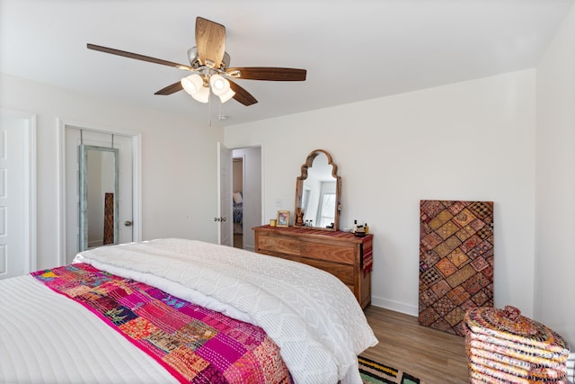 bedroom with hardwood / wood-style floors and ceiling fan