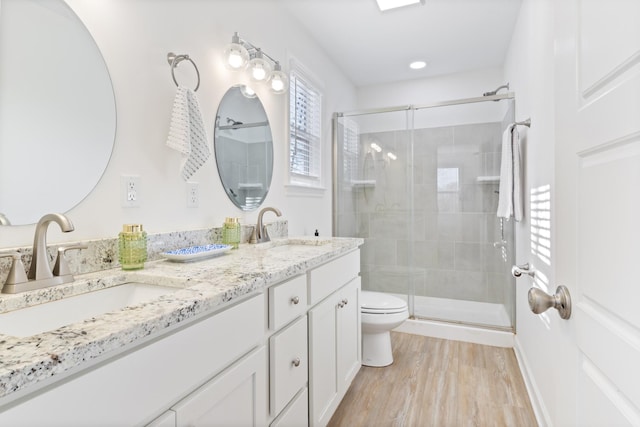 bathroom featuring hardwood / wood-style flooring, vanity, toilet, and an enclosed shower