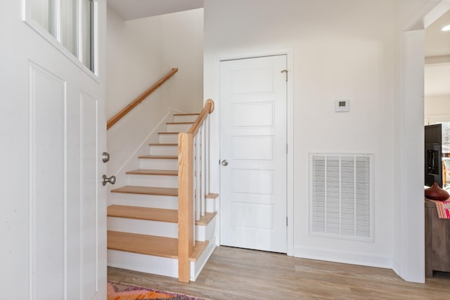 stairs featuring wood-type flooring