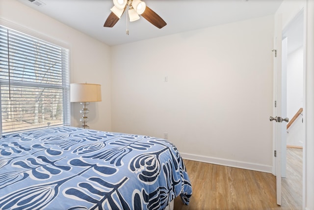 bedroom with hardwood / wood-style flooring and ceiling fan