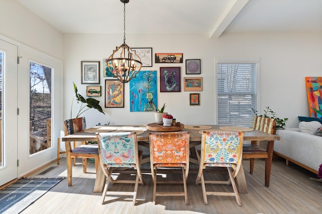 dining area with an inviting chandelier, hardwood / wood-style floors, and beamed ceiling