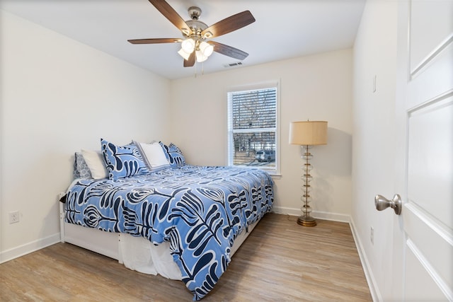 bedroom with hardwood / wood-style floors and ceiling fan