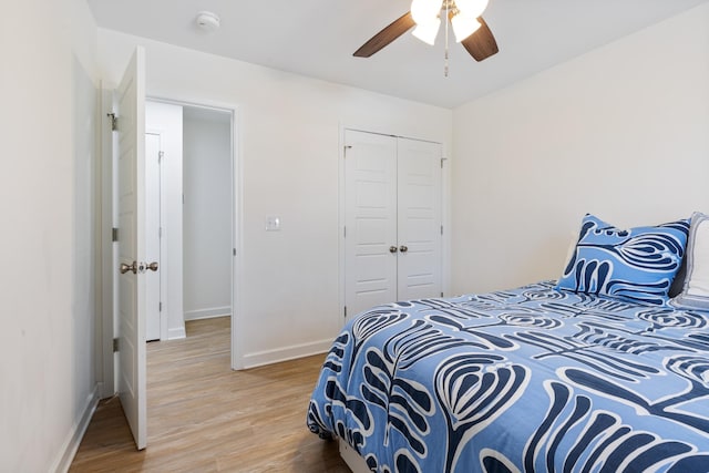 bedroom with hardwood / wood-style floors, a closet, and ceiling fan