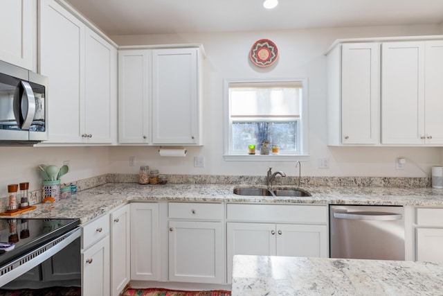 kitchen featuring stainless steel appliances, sink, and white cabinets