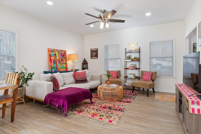 living room featuring ceiling fan and light wood-type flooring