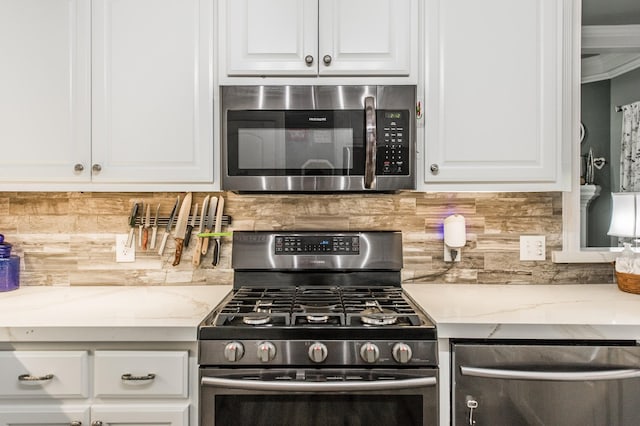 kitchen featuring white cabinetry, tasteful backsplash, and appliances with stainless steel finishes