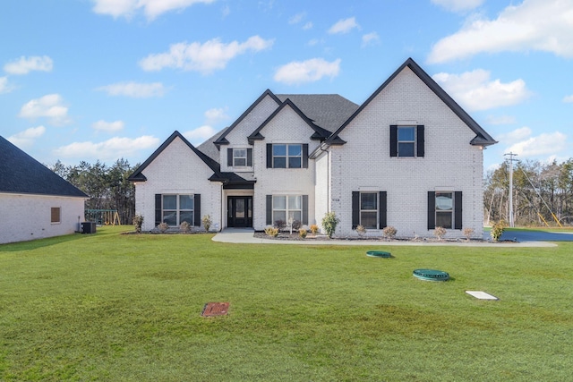 rear view of property featuring central AC unit and a lawn