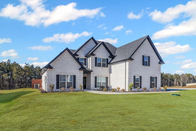 view of front of home with a front yard and central air condition unit