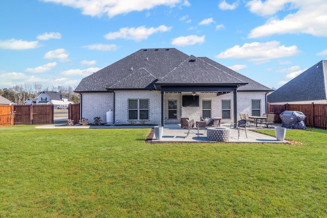 rear view of house featuring a lawn, a patio, and an outdoor fire pit