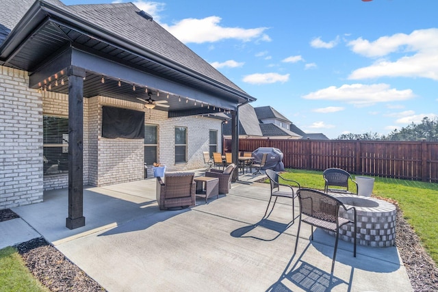 view of patio / terrace with grilling area, an outdoor living space with a fire pit, and ceiling fan