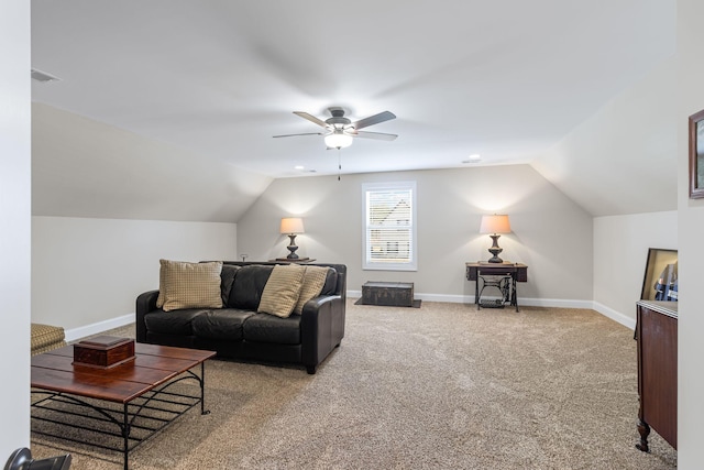 living room with ceiling fan, carpet floors, and vaulted ceiling