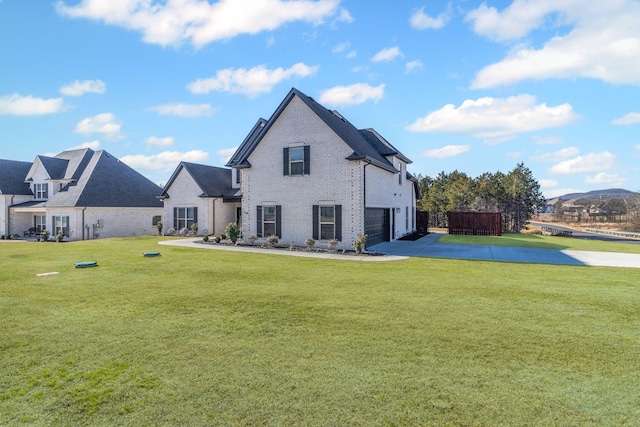 back of property with a garage and a yard