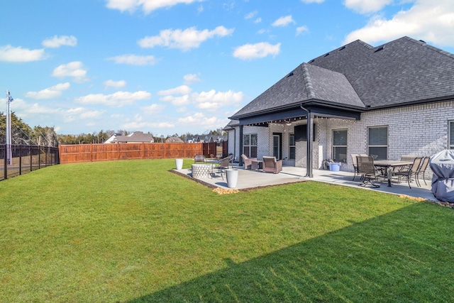 rear view of house featuring a patio area and a lawn