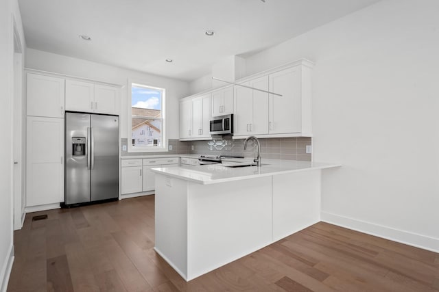 kitchen featuring white cabinetry, stainless steel appliances, and sink