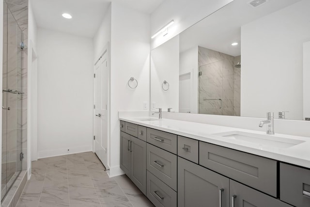 bathroom featuring vanity and a shower with shower door