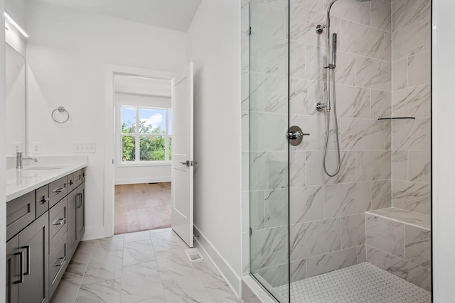 bathroom featuring vanity and tiled shower