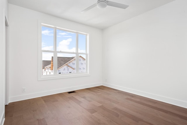 spare room with wood-type flooring and ceiling fan