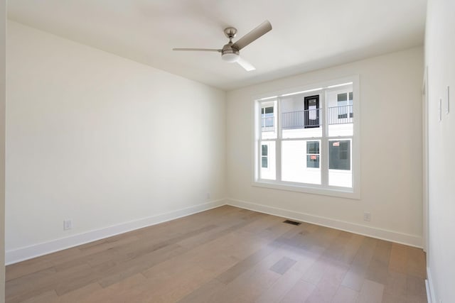 spare room featuring light hardwood / wood-style floors and ceiling fan