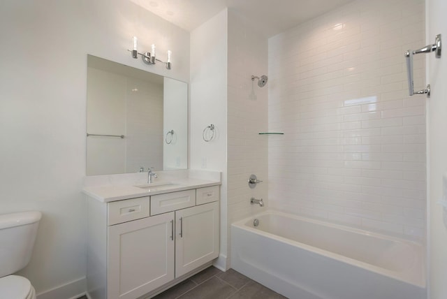 full bathroom featuring tile patterned floors, toilet, tiled shower / bath combo, and vanity