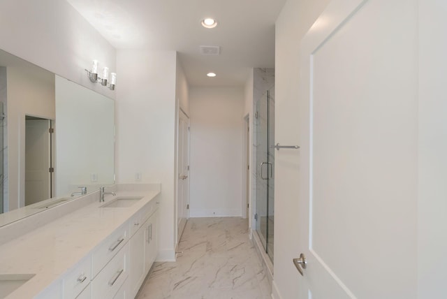 bathroom with a shower with door and vanity